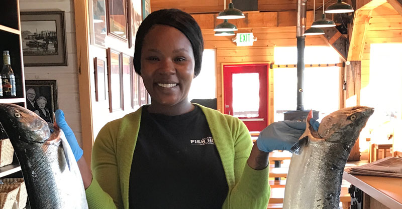 Latoya holding up fresh silver salmon